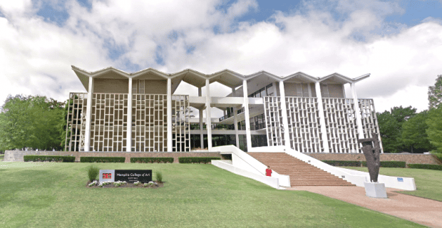 Memphis Heritage Inc. building with modern architecture featuring geometric design, large windows, and located on a lush green landscape under partly cloudy skies in Memphis.