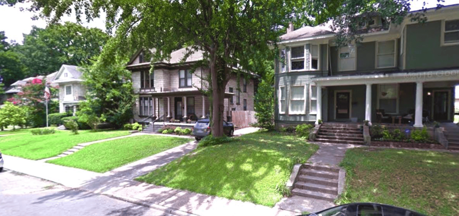 Beautiful historic residential homes in Memphis, Tennessee showcasing classic Victorian architecture and lush landscaping, an integral part of Memphis Heritage Inc.'s preservation efforts.