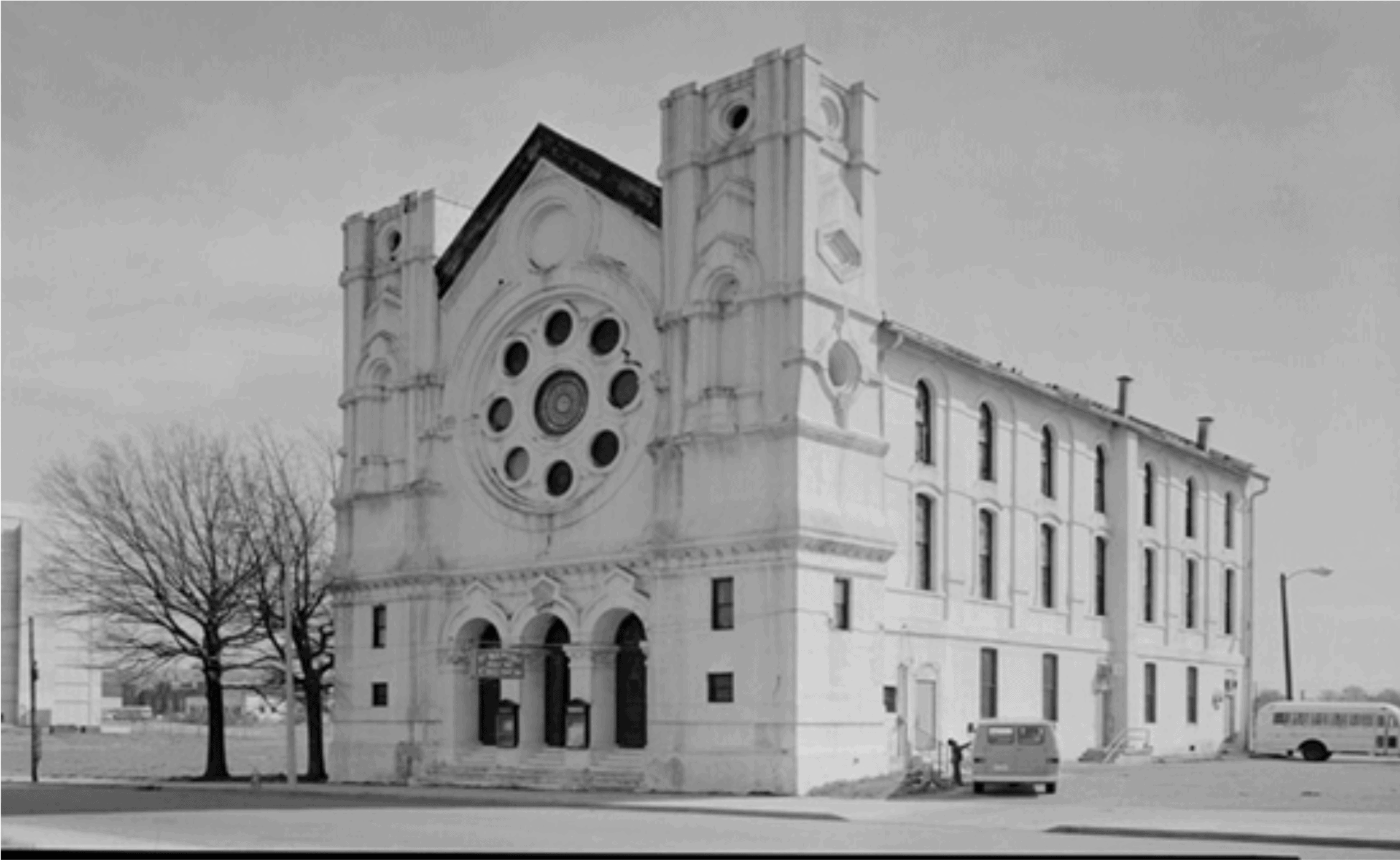 Weathered historic church building in Memphis, Tennessee, showcasing classic architecture with tall arched windows, decorative stonework, and a prominent circular window, representing Memphis Heritage Inc. history.